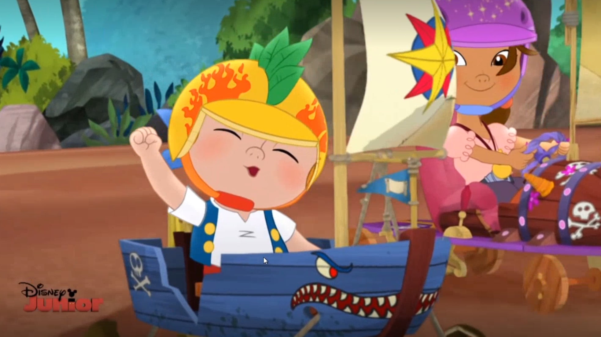 A cartoon image of a young boy wearing a helmet and sitting in a blue pirate ship