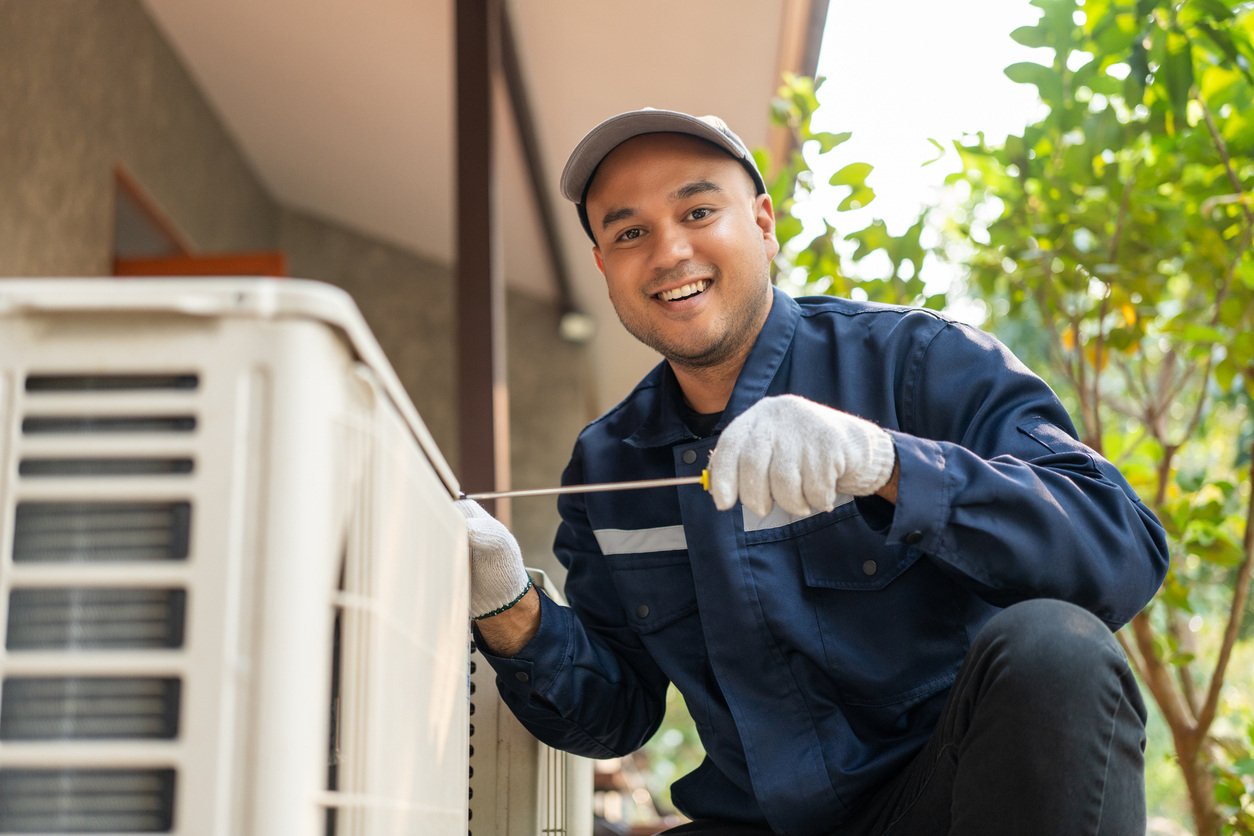 HVAC technician servicing an air conditioning unit