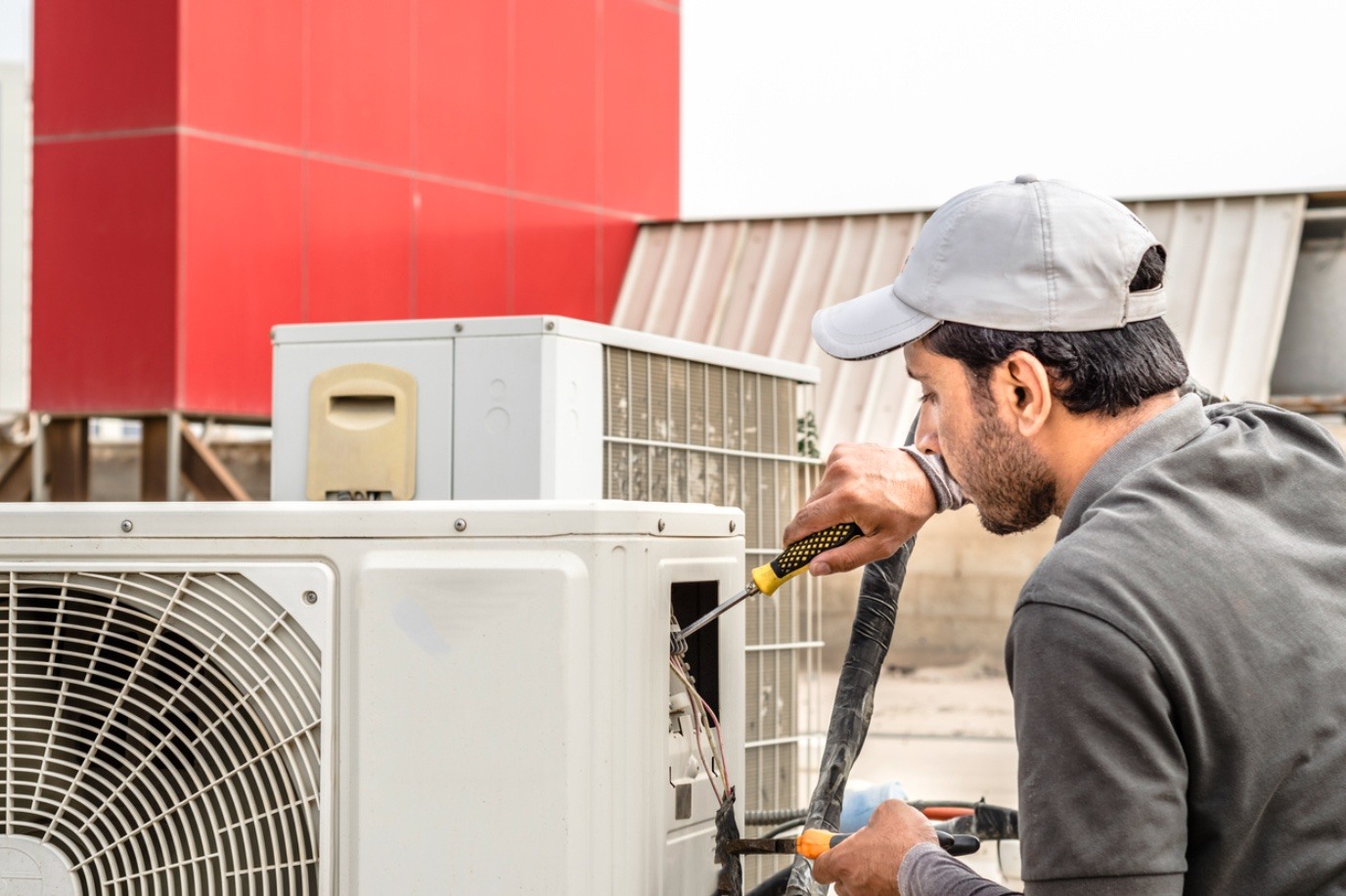 HVAC technician working on AC unit