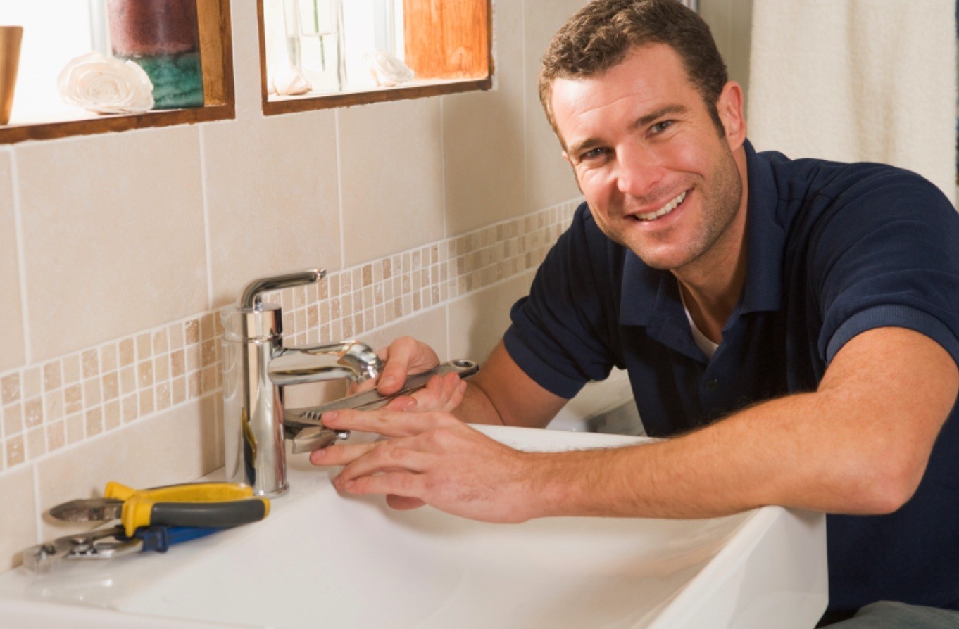 Plumber fixing faucet