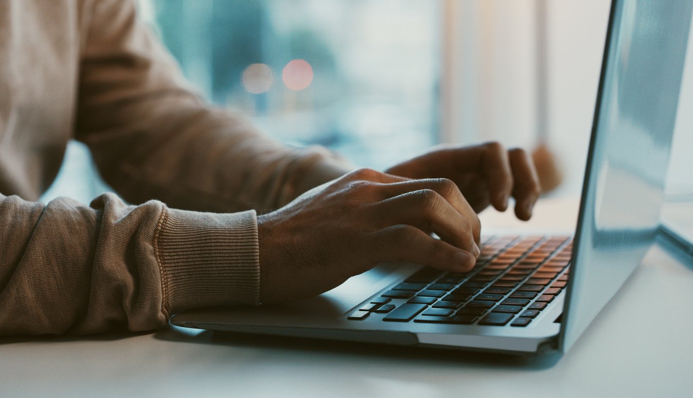 Closeup of hands typing on laptop