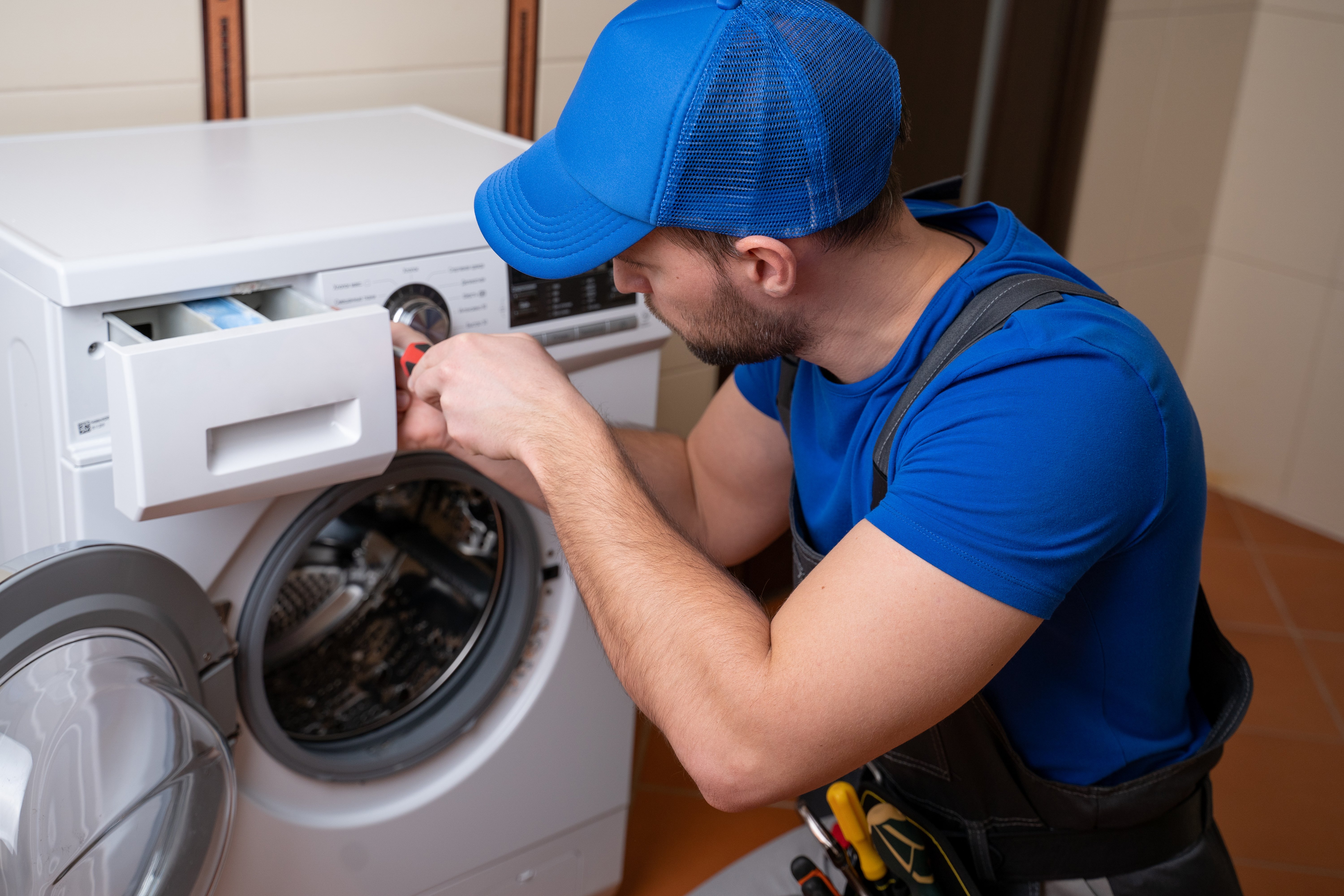 Worker fixing washing machine