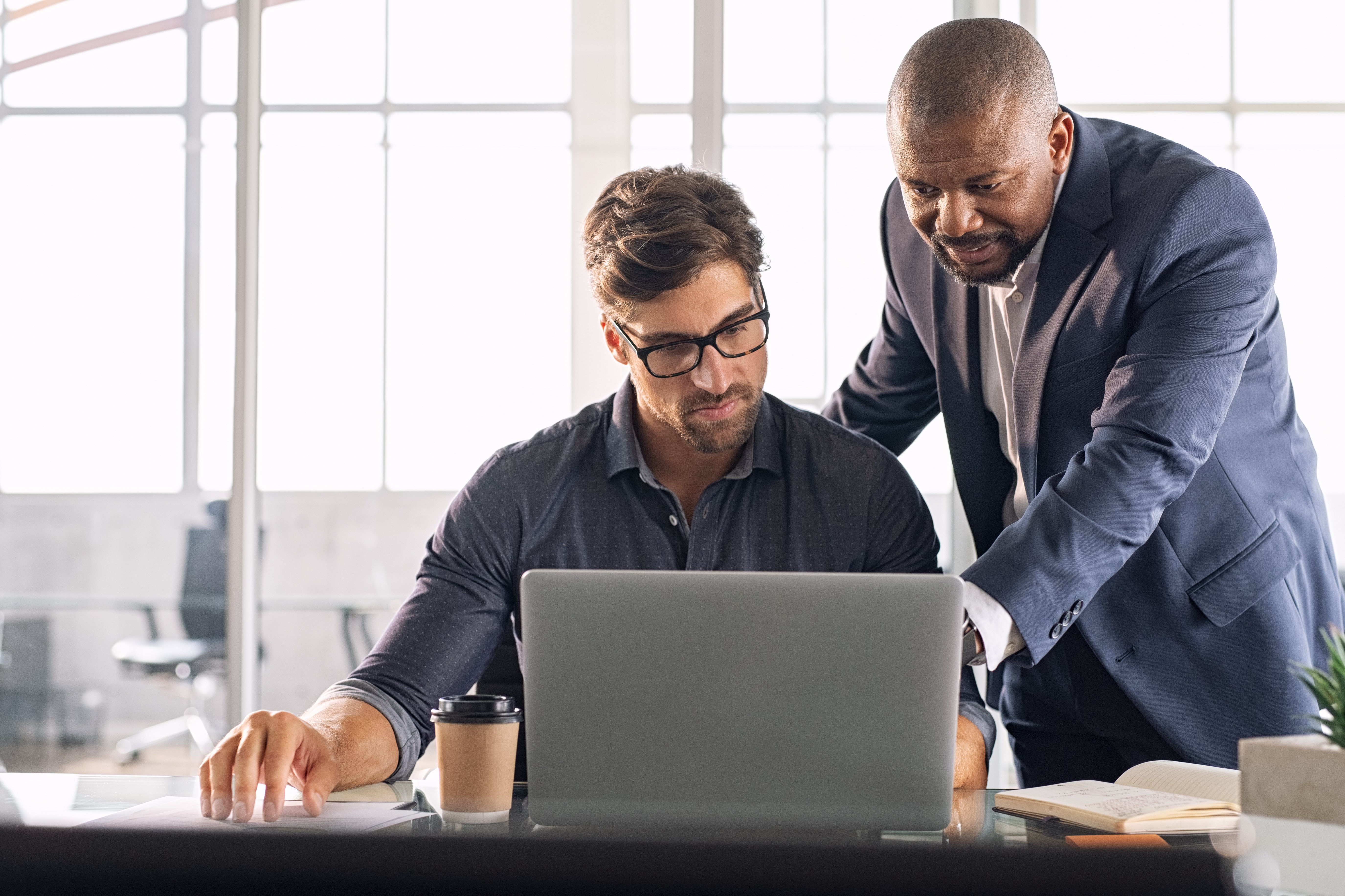 Young businessman getting help from boss