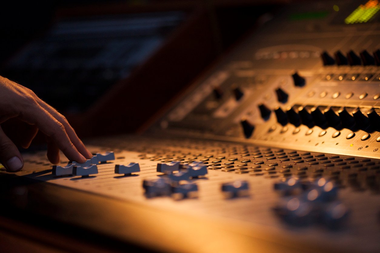 Close-up of a hand on a sound mixer