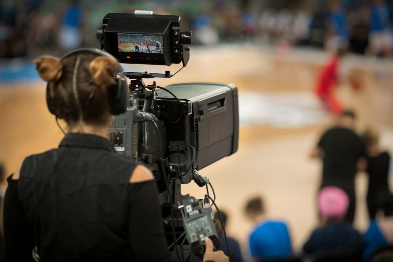 Camerawoman shooting basketball game