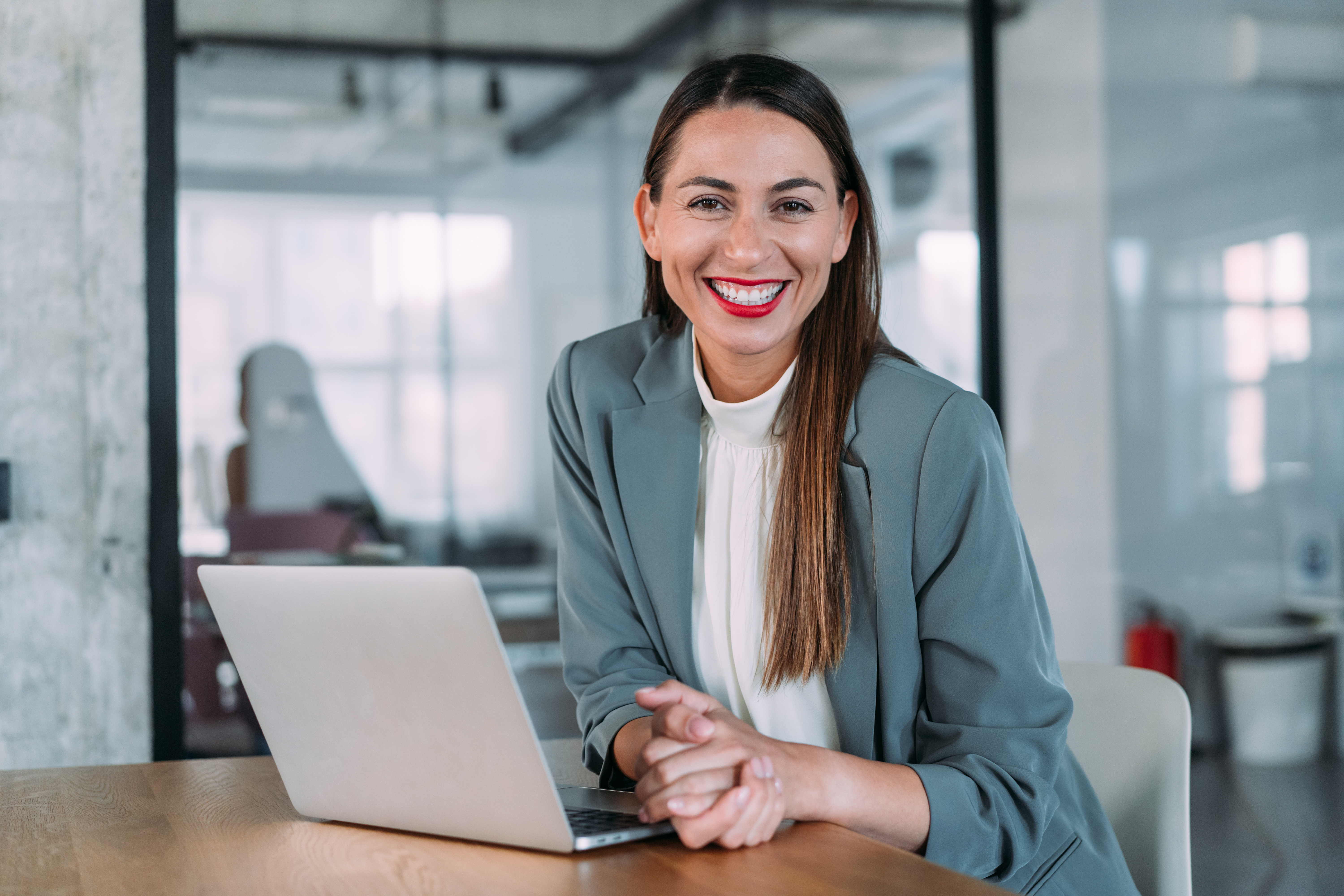 Smiling career counsellor sitting with laptop