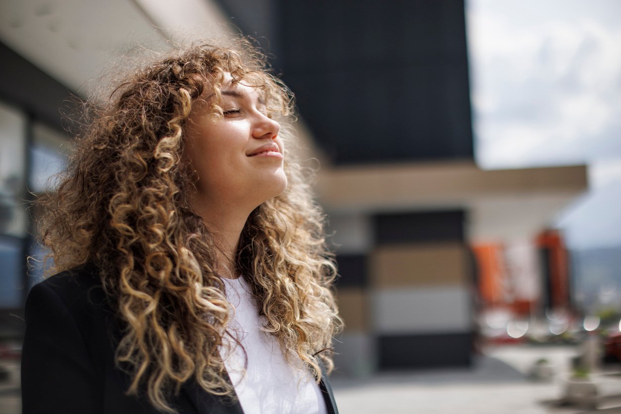 Professional woman relaxing outside with eyes closed