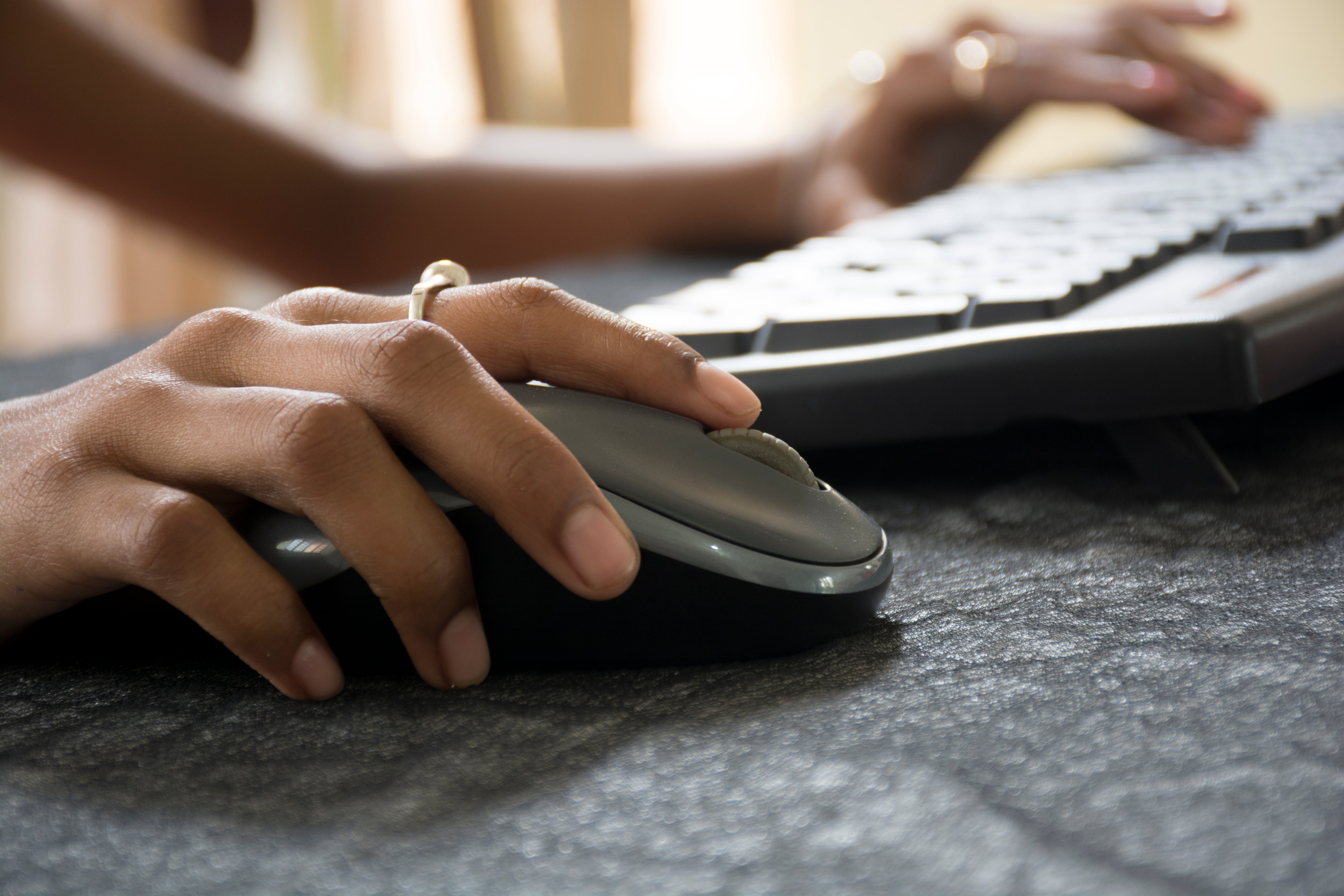 Closeup of a woman's hand on a computer mouse