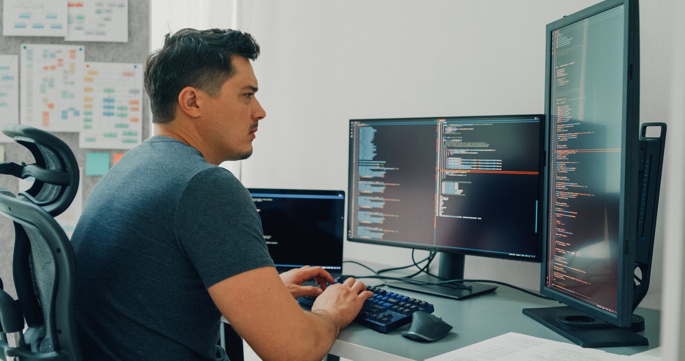 Security specialist sitting in front of two monitor