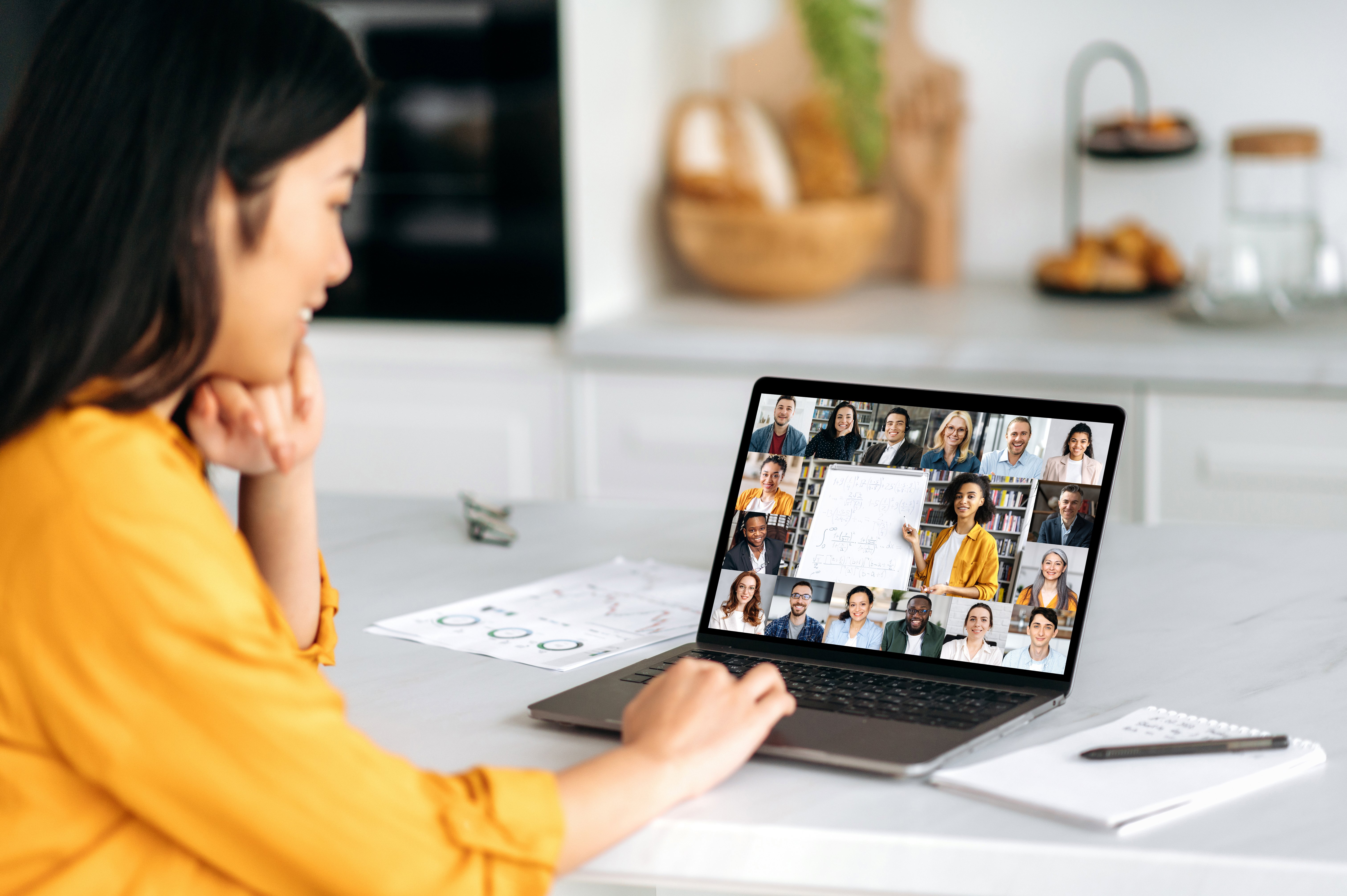 Young professional woman listening to an online lecture