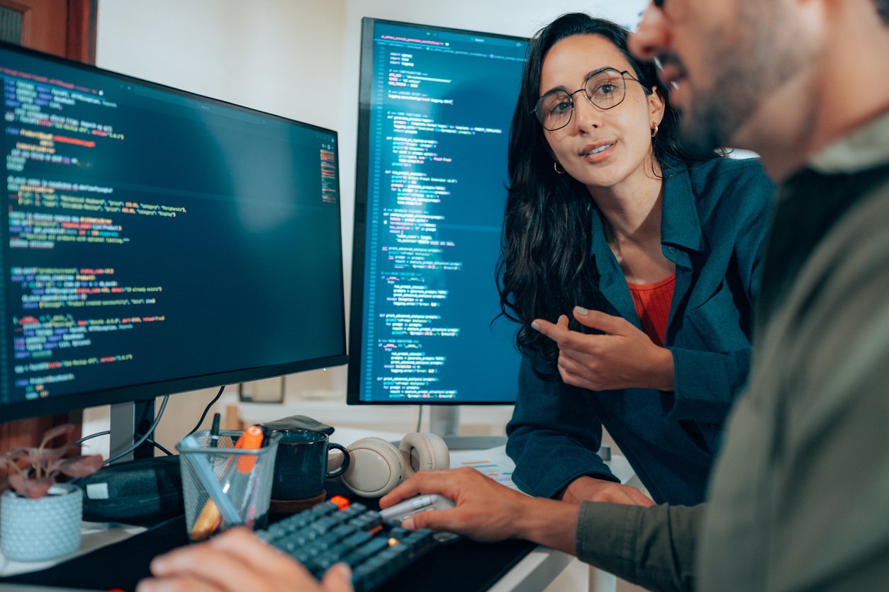 Cyber professionals reviewing code together
