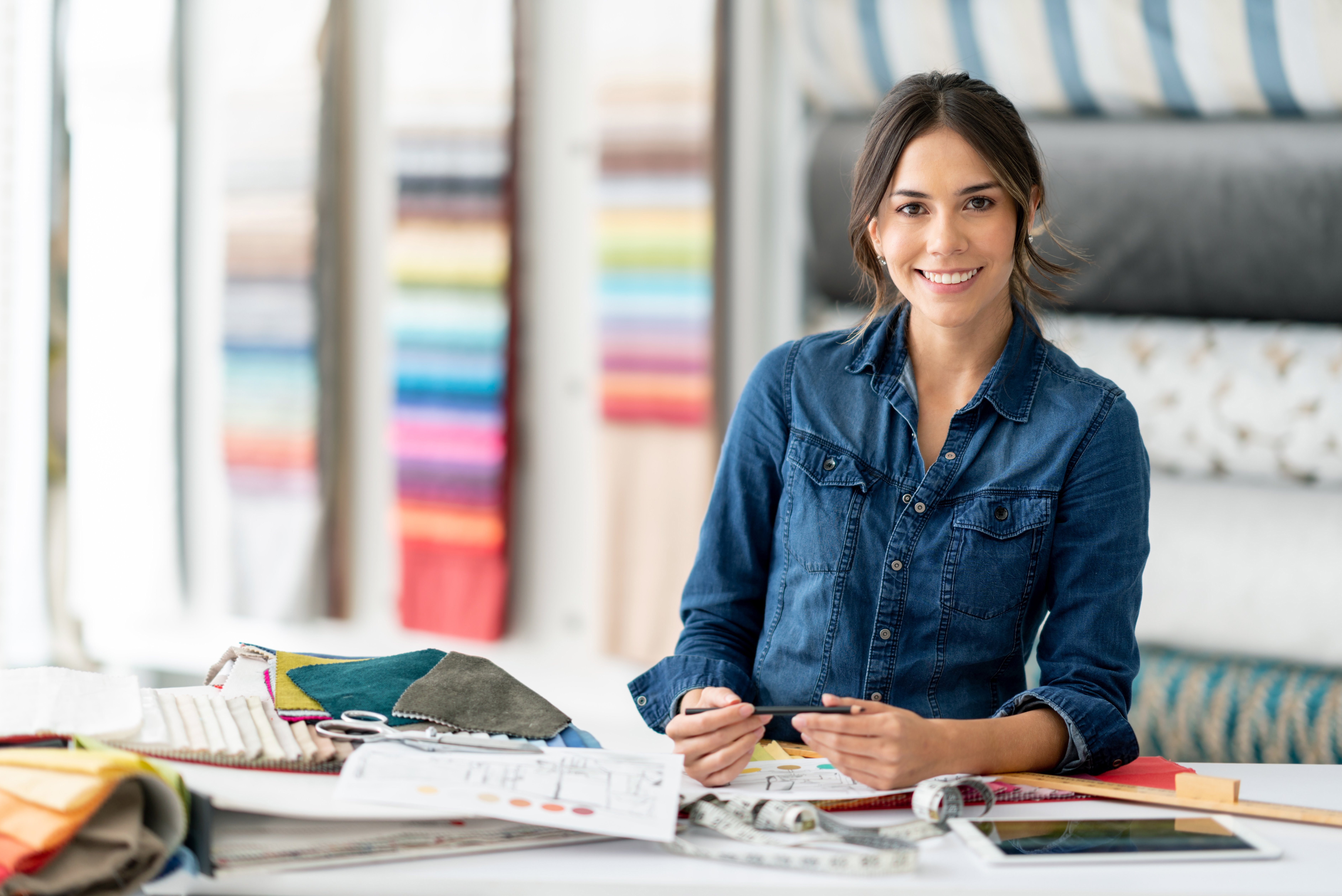 Interior designer at her workshop choosing fabrics