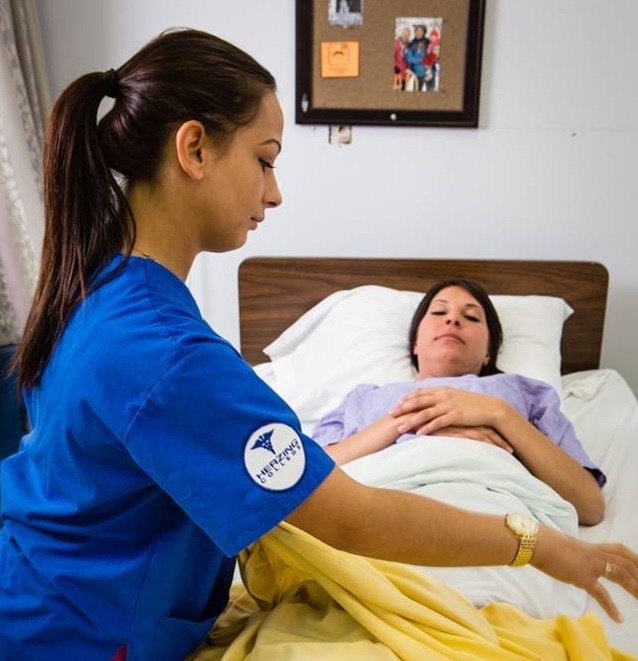 Health Care Aide student helping a patient