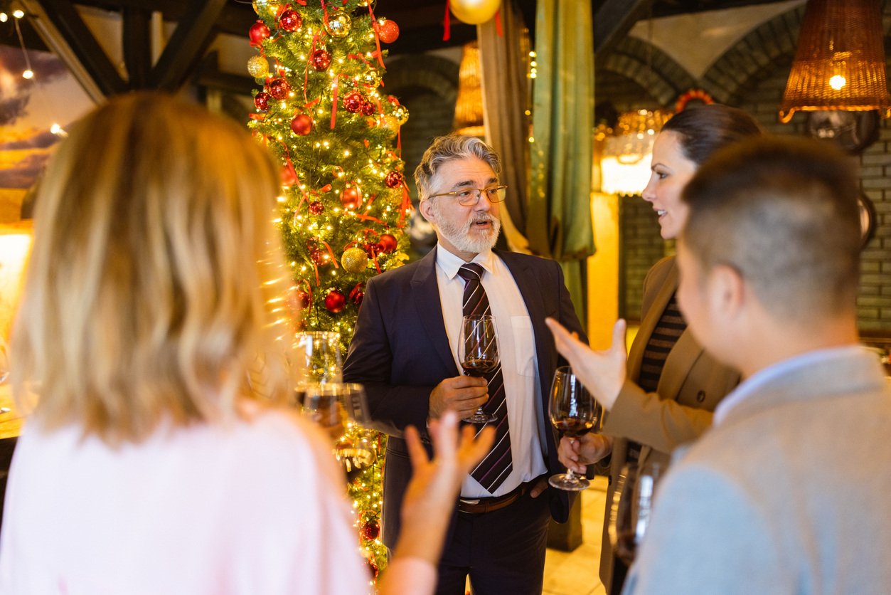 Professionals talking near Christmas tree