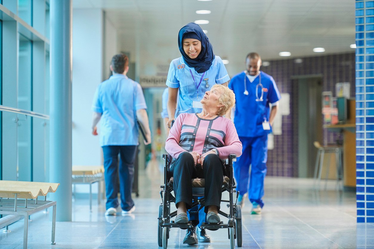 Hospital volunteer with elderly patient