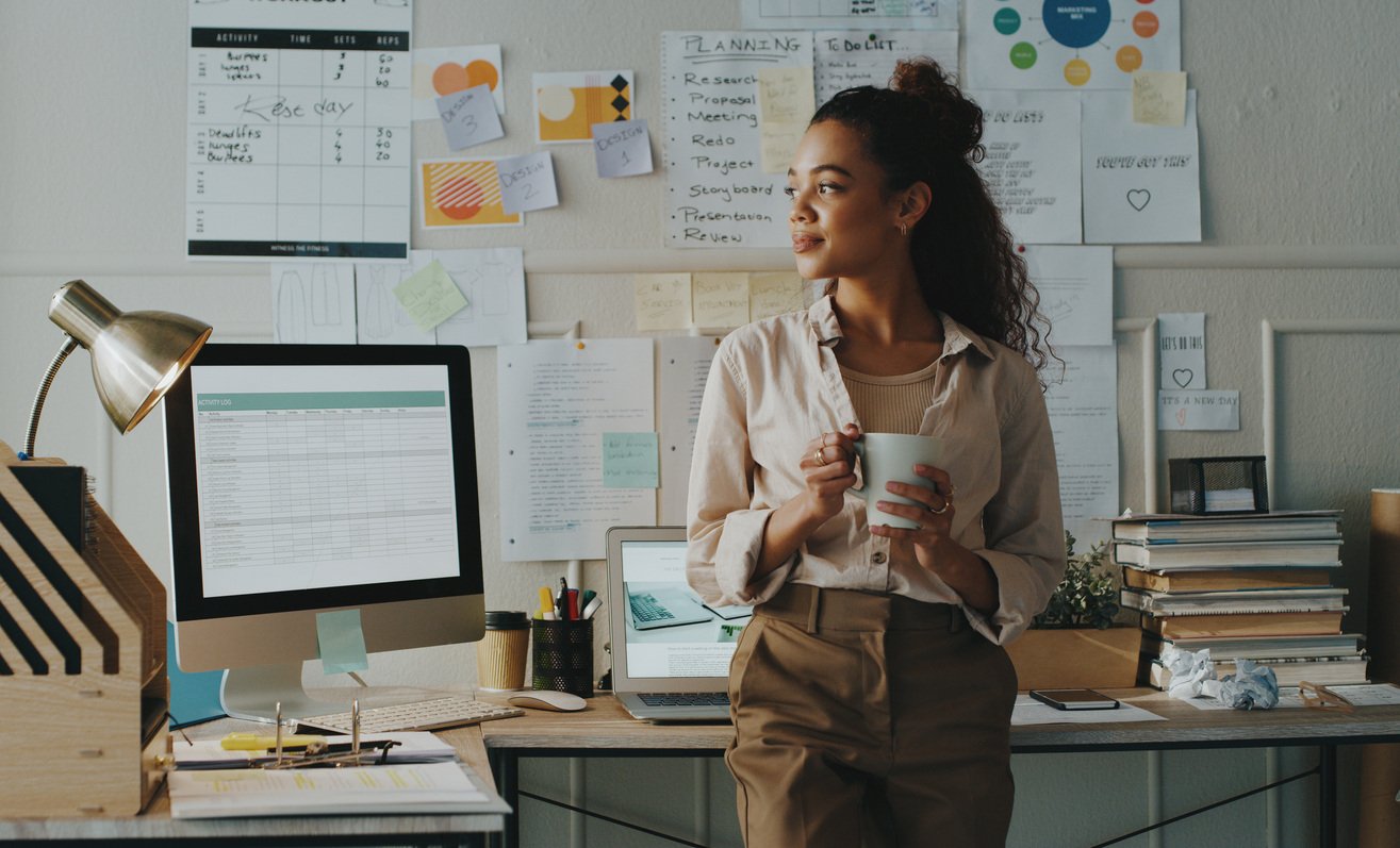 Woman standing and looking contemplative in office