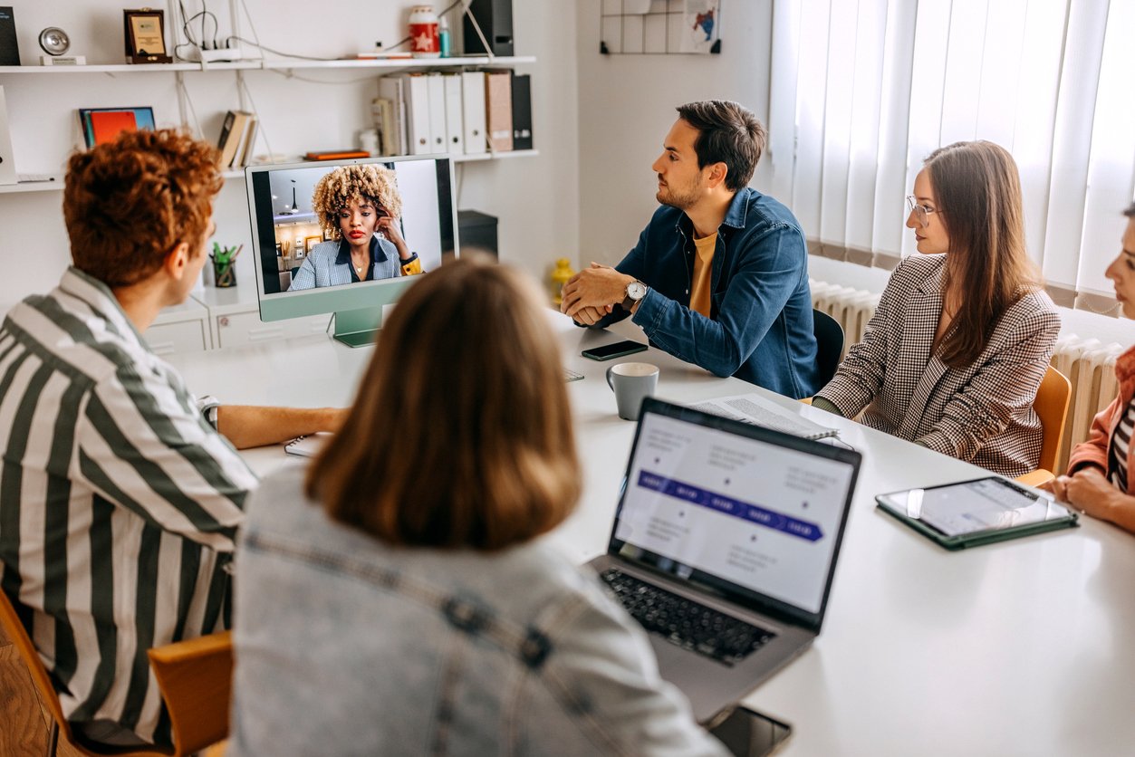 Colleagues on a video meeting in a conference room