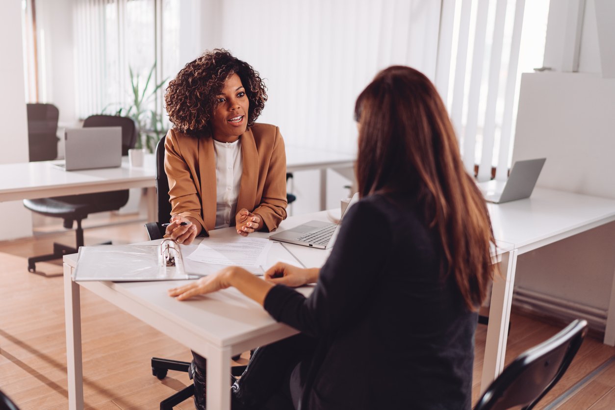 Case manager going through a binder with a client