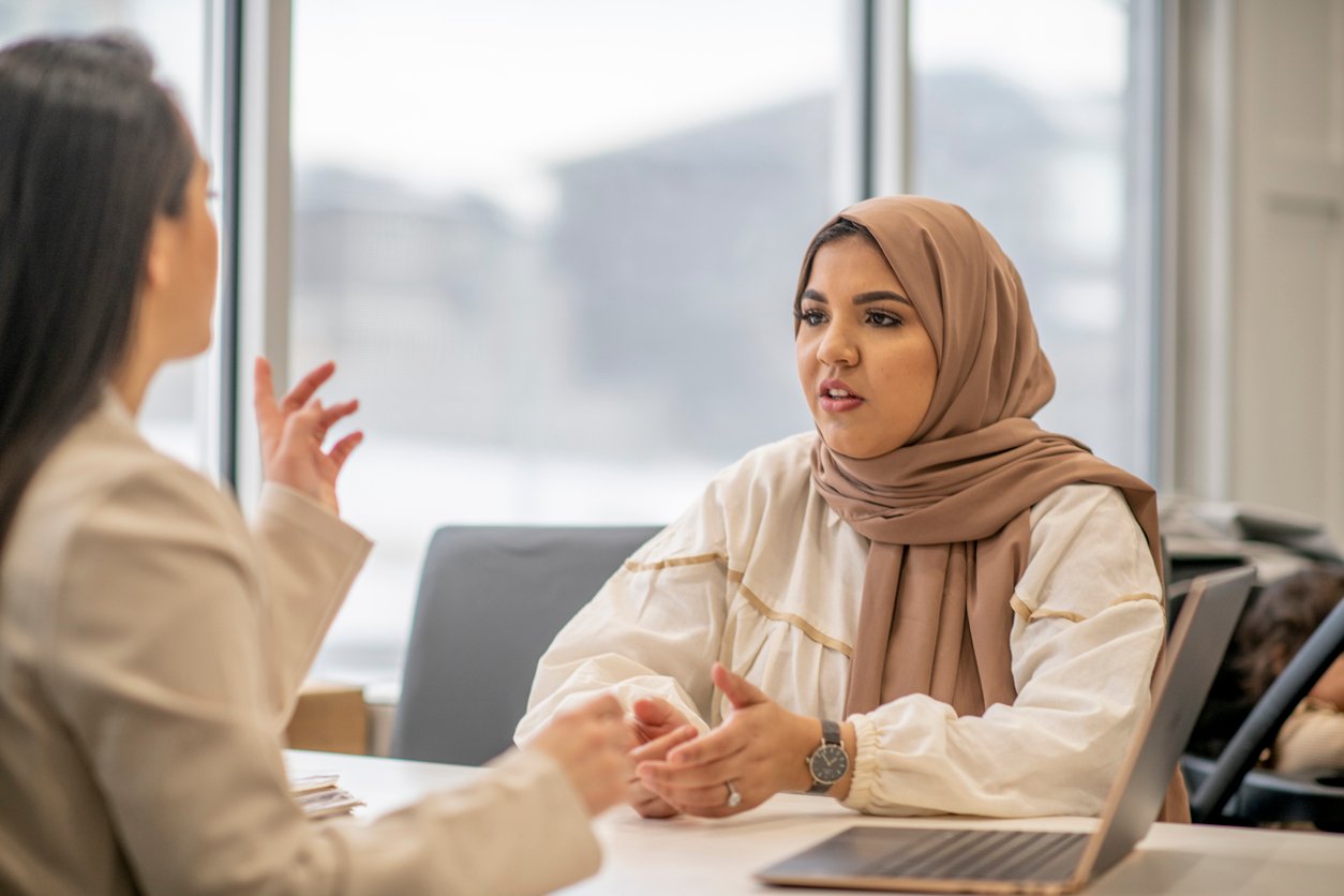 Muslim woman talking to immigration case manager