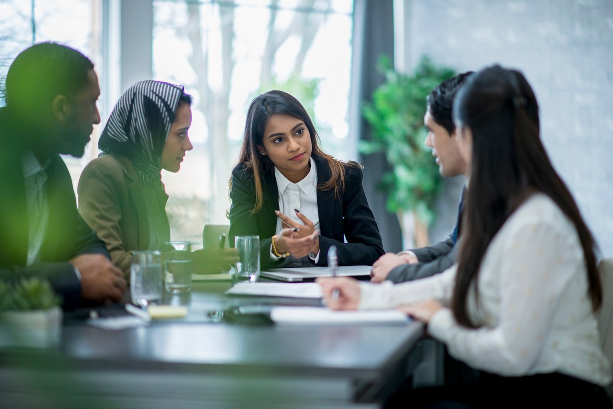 Group of people sitting around a conference table