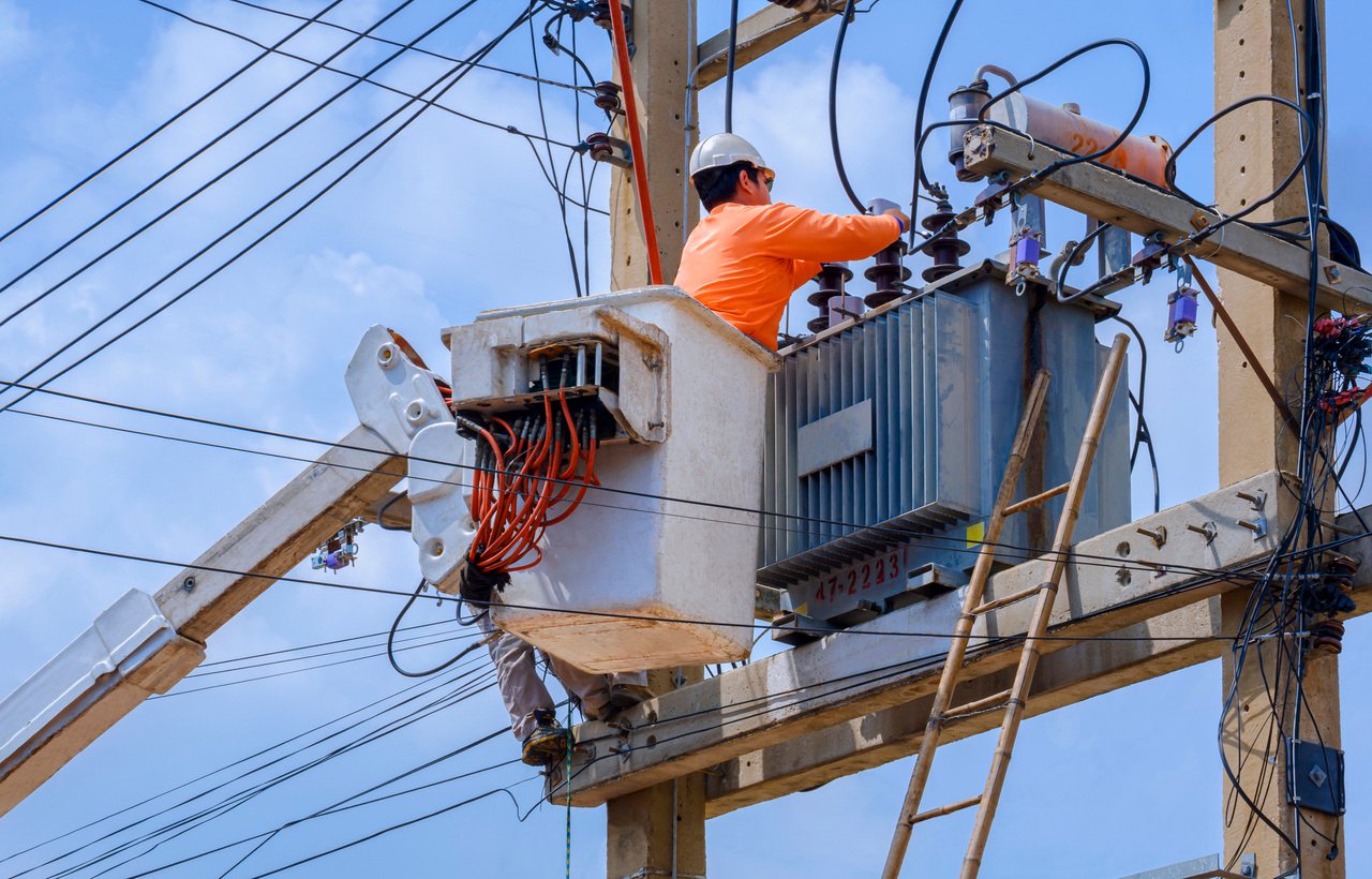 Powerline electrician in articulated boom lift