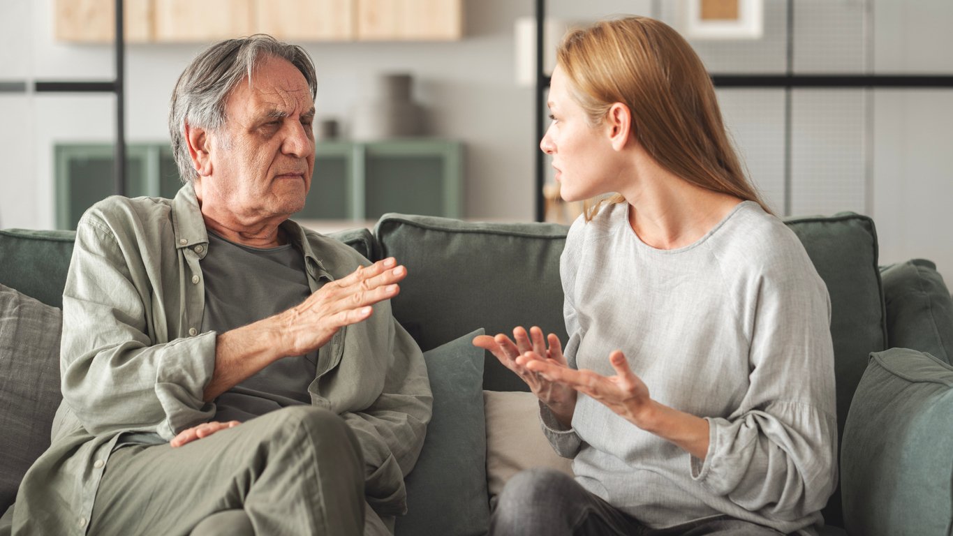 Father and daughter arguing on couch