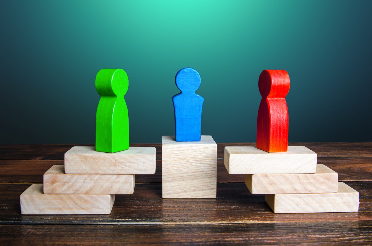 hree wooden figures representing the parties in a mediation