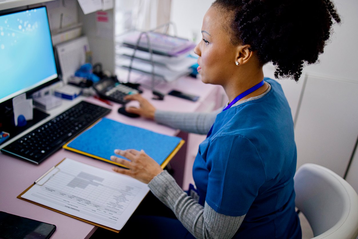 Medical office administrator using computer