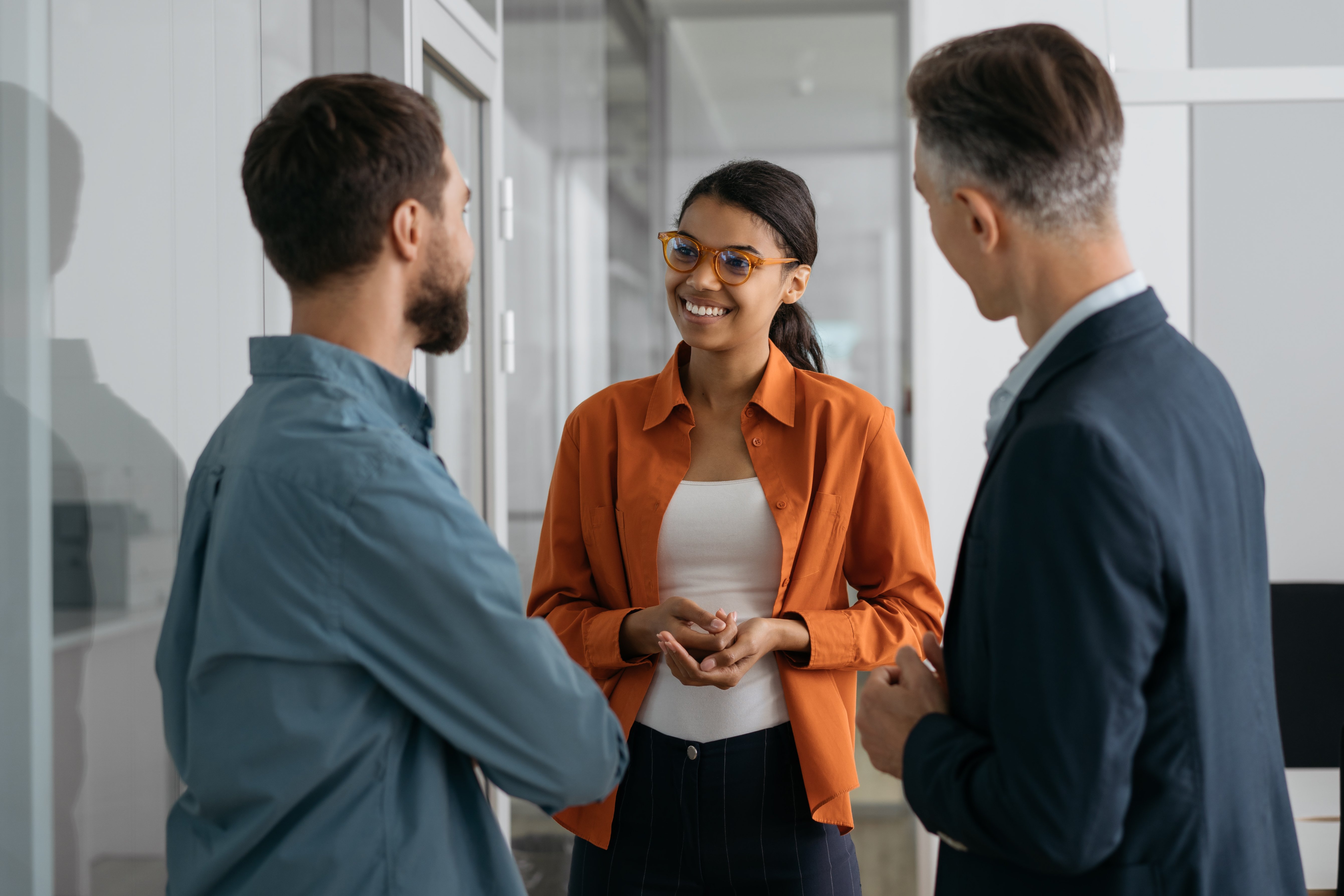 Smiling woman talking to two colleagues