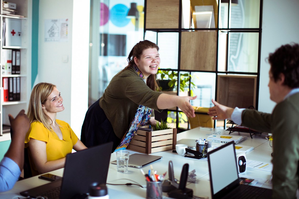 Young woman meeting her new colleagues in the office