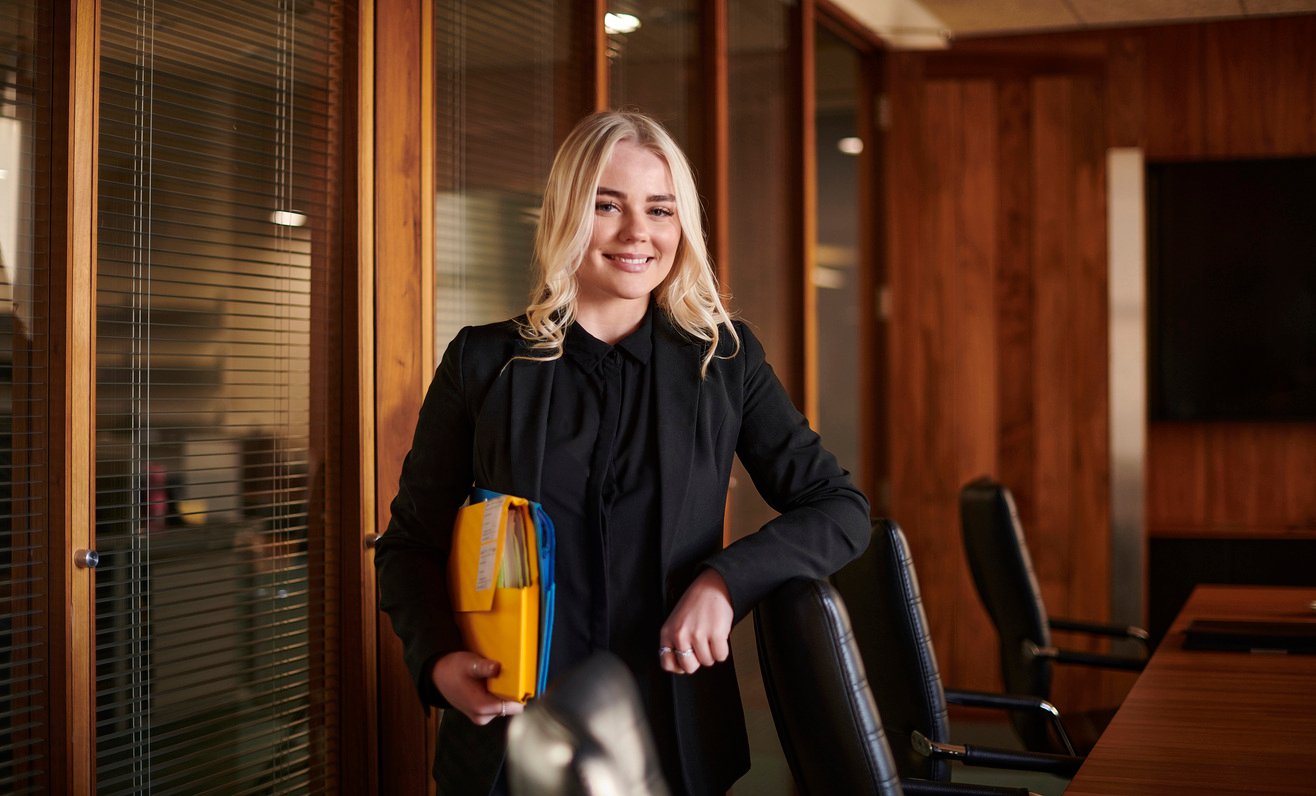 Paralegal standing in conference room