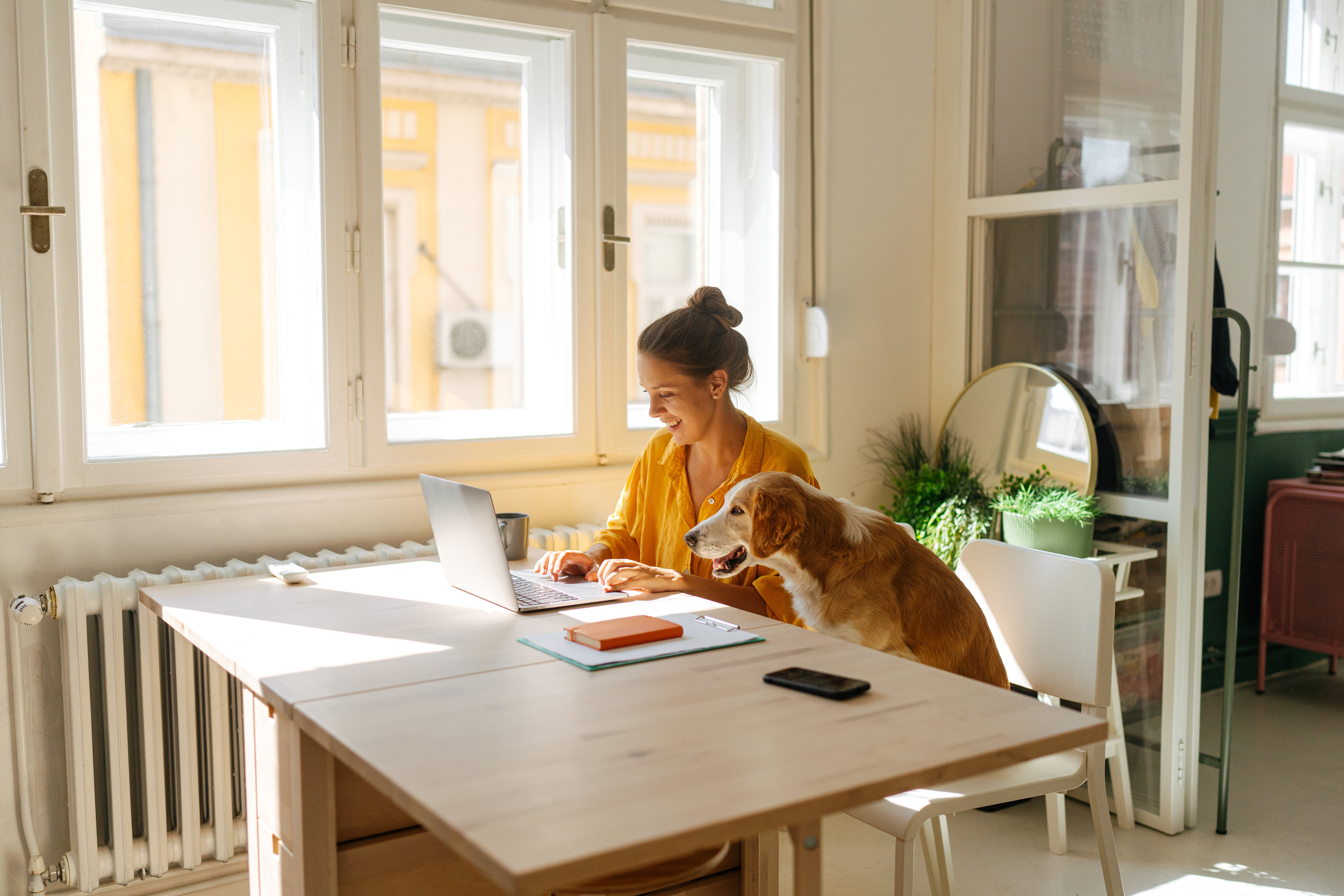 Woman working from home alongside her dog
