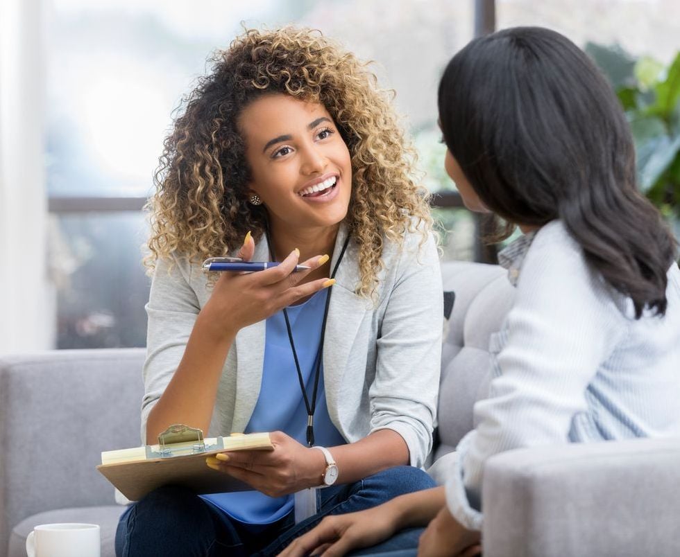 Encouraging therapist talks with young woman
