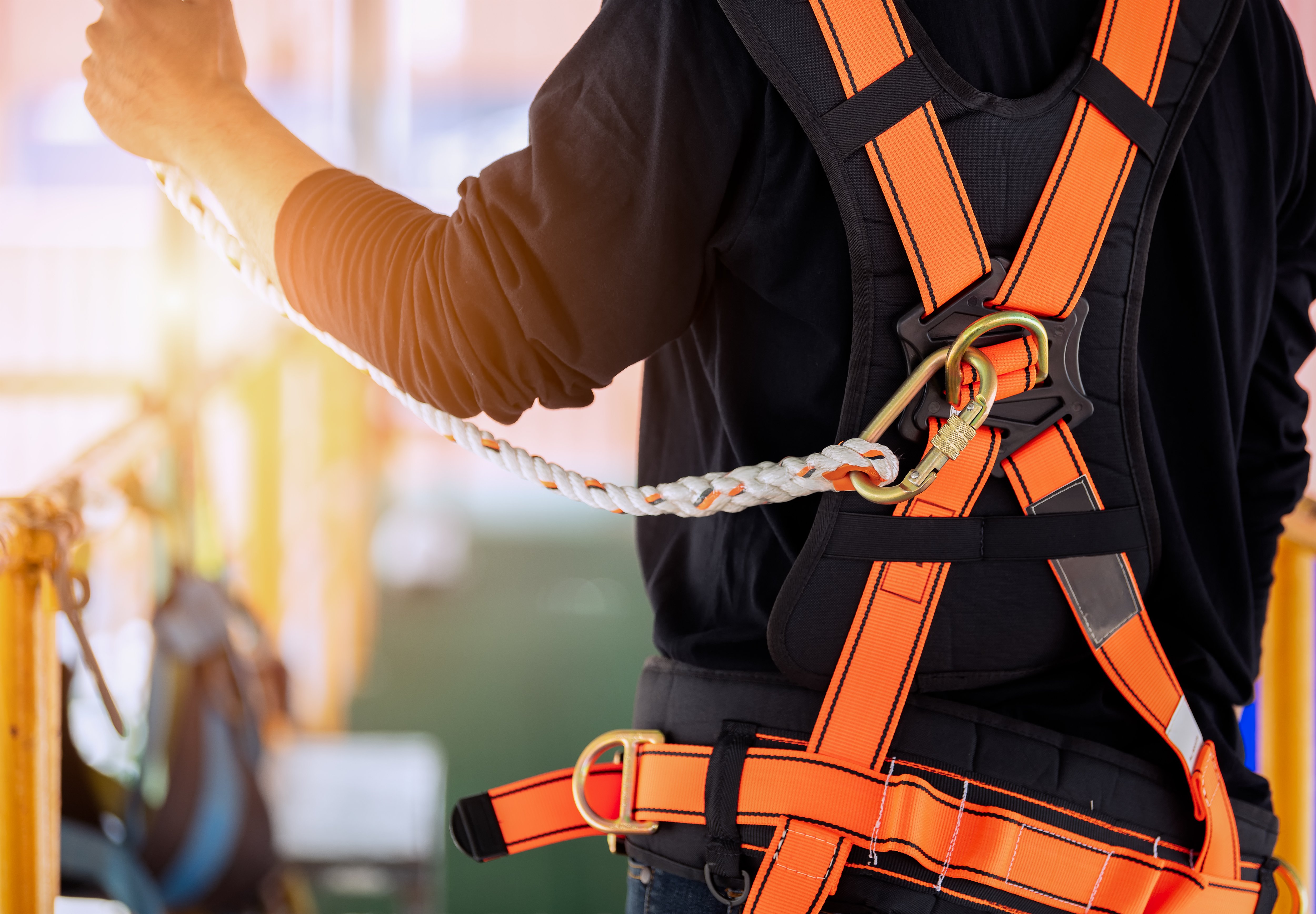Construction worker wearing safety harness
