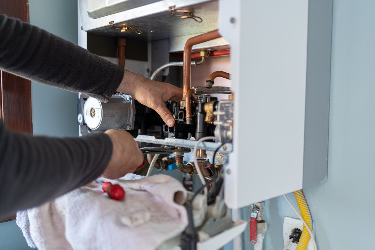 Technician repairing a boiler