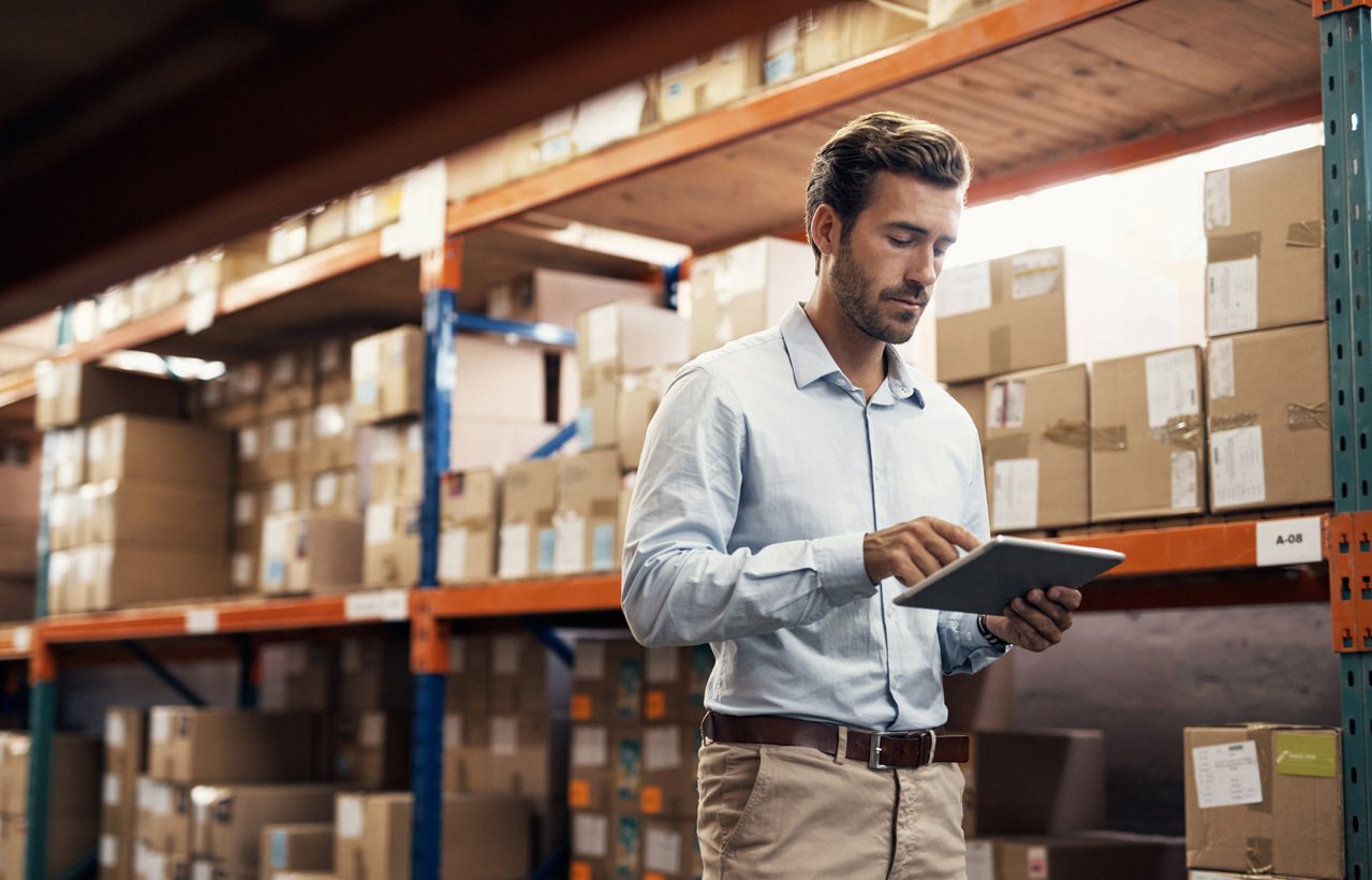 Man using tablet while working in a warehouse