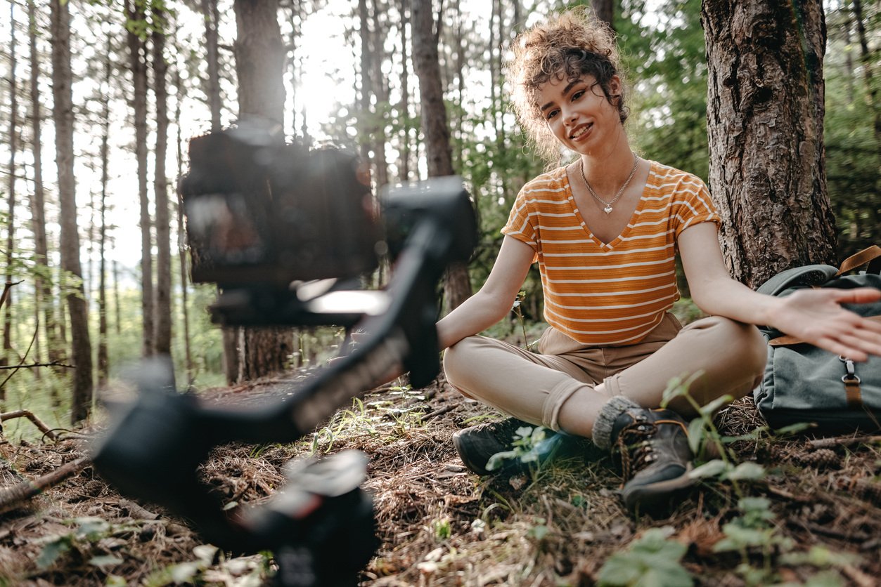 Influencer vlogging while spending time alone in forest