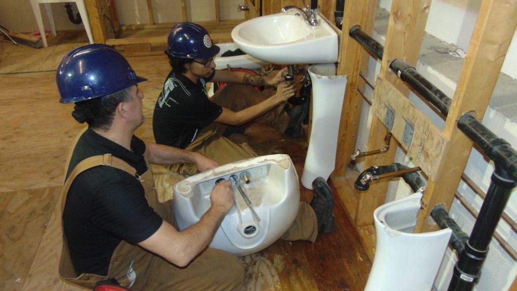 Plumbing students in workshop