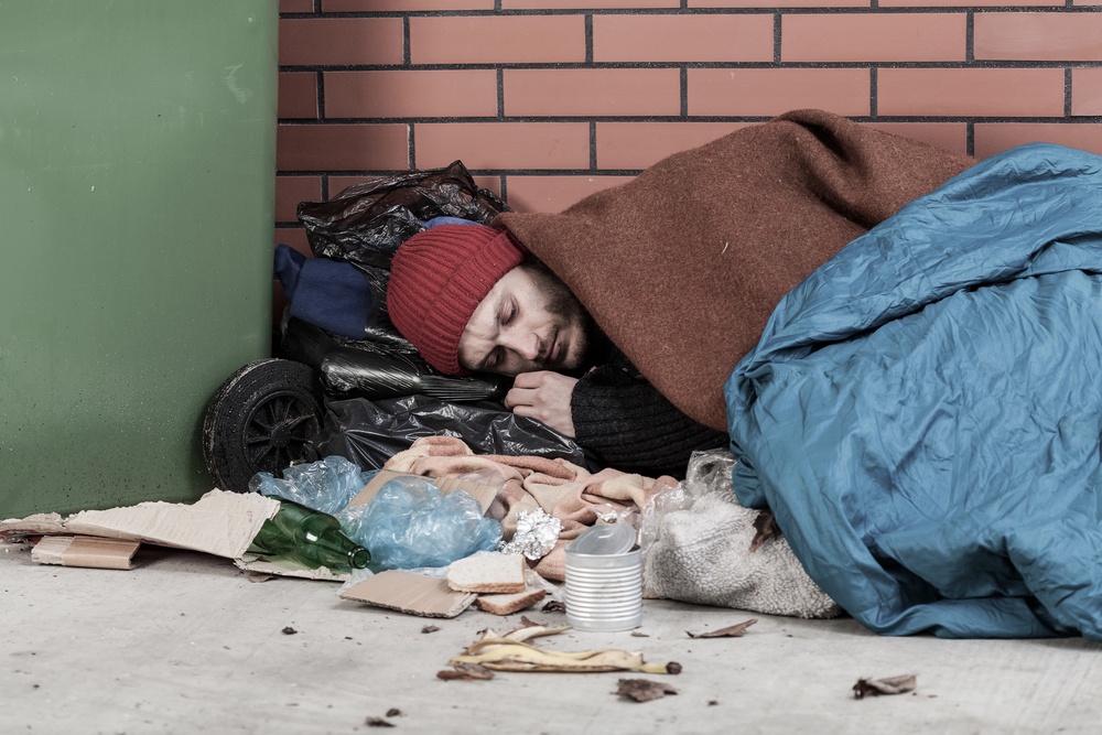 Poor man sleeping on the street, horizontal.jpeg