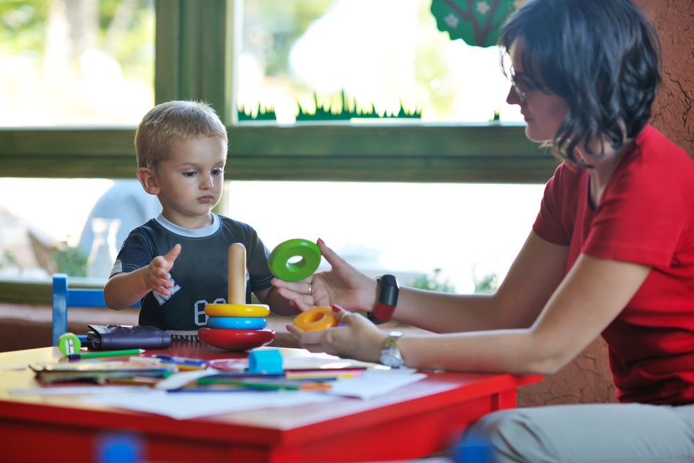 happy little child play game and have fun, education lessons in colorful kinder garden playground indoors.jpeg
