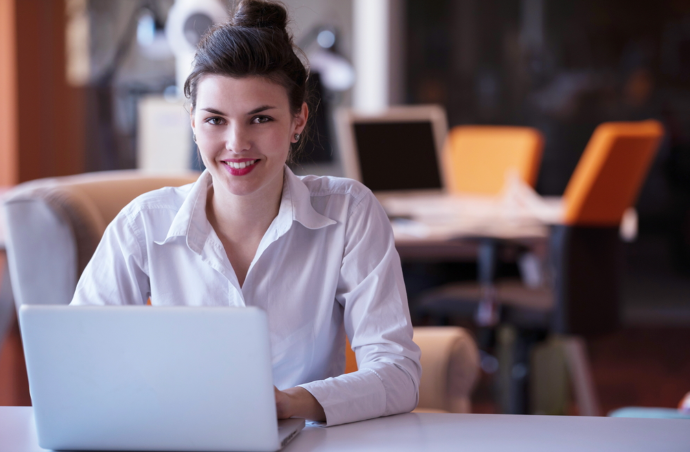 Woman sitting at laptop in office