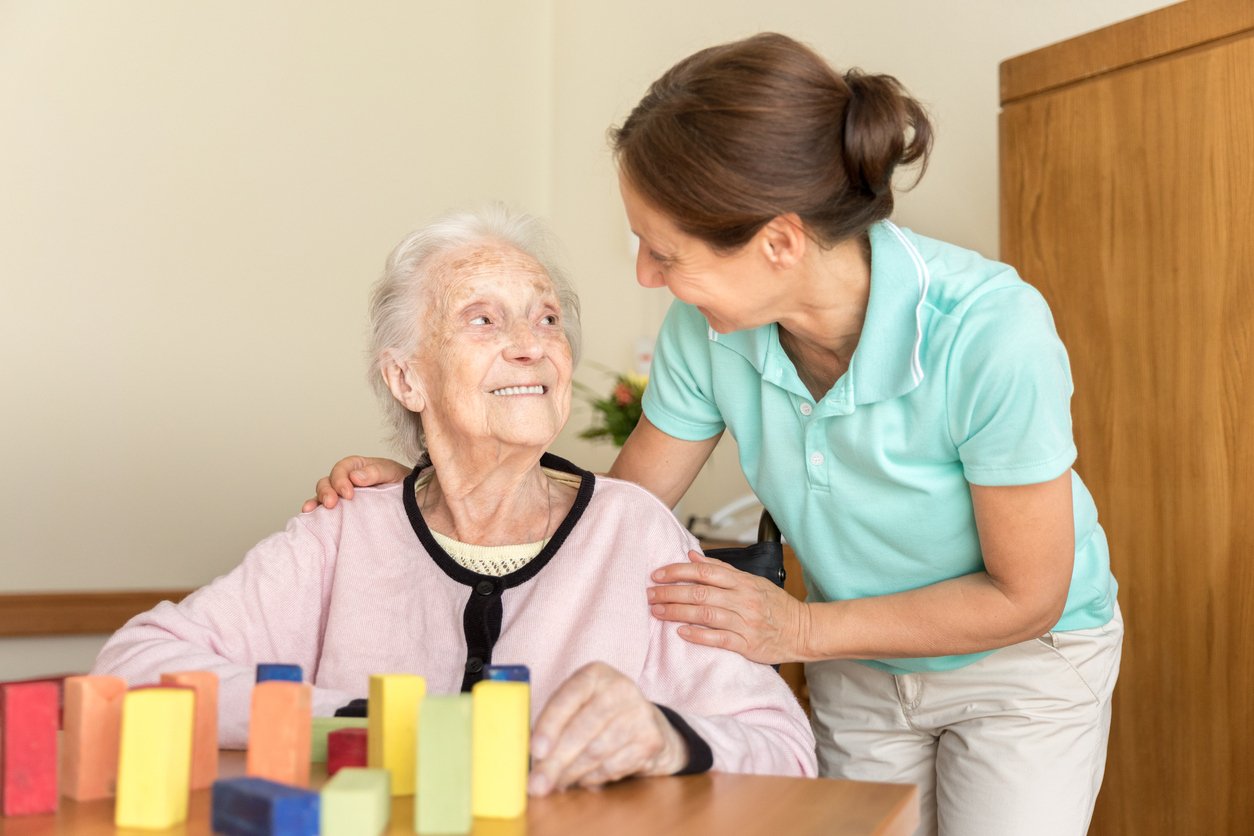 Home caregiver and senior adult woman