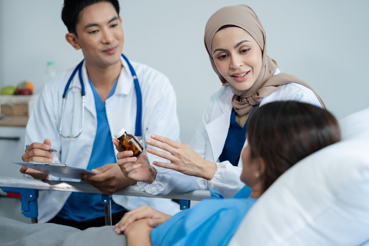Healthcare team talking to patient in bed