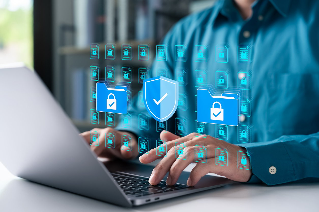 Cybersecurity concept with man using laptop to protect data folders and digital files