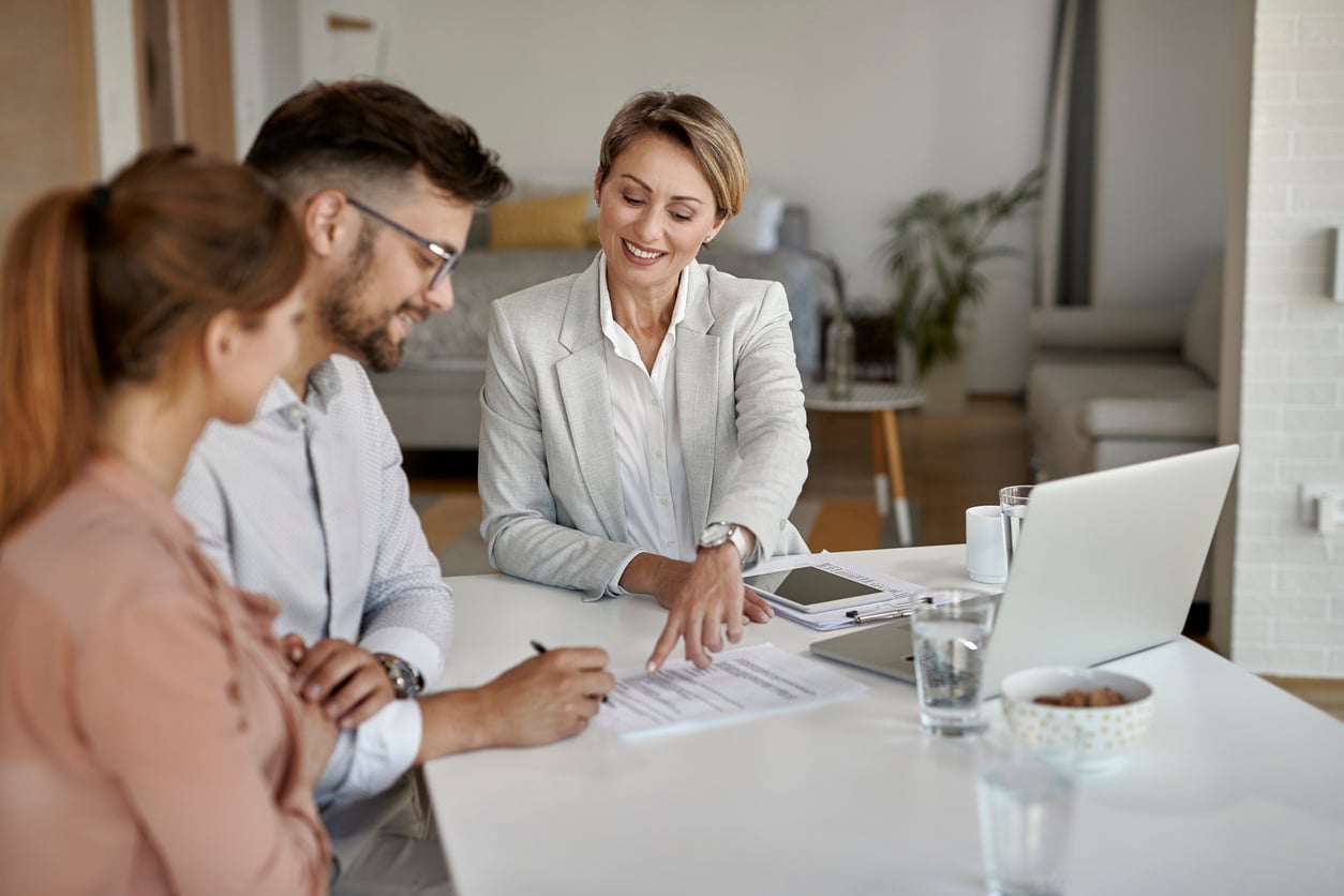 Insurance agent going over paperwork with clients