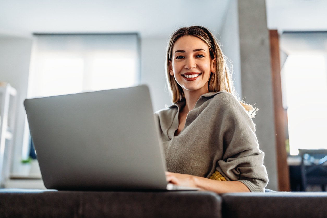 Smiling woman working on laptop