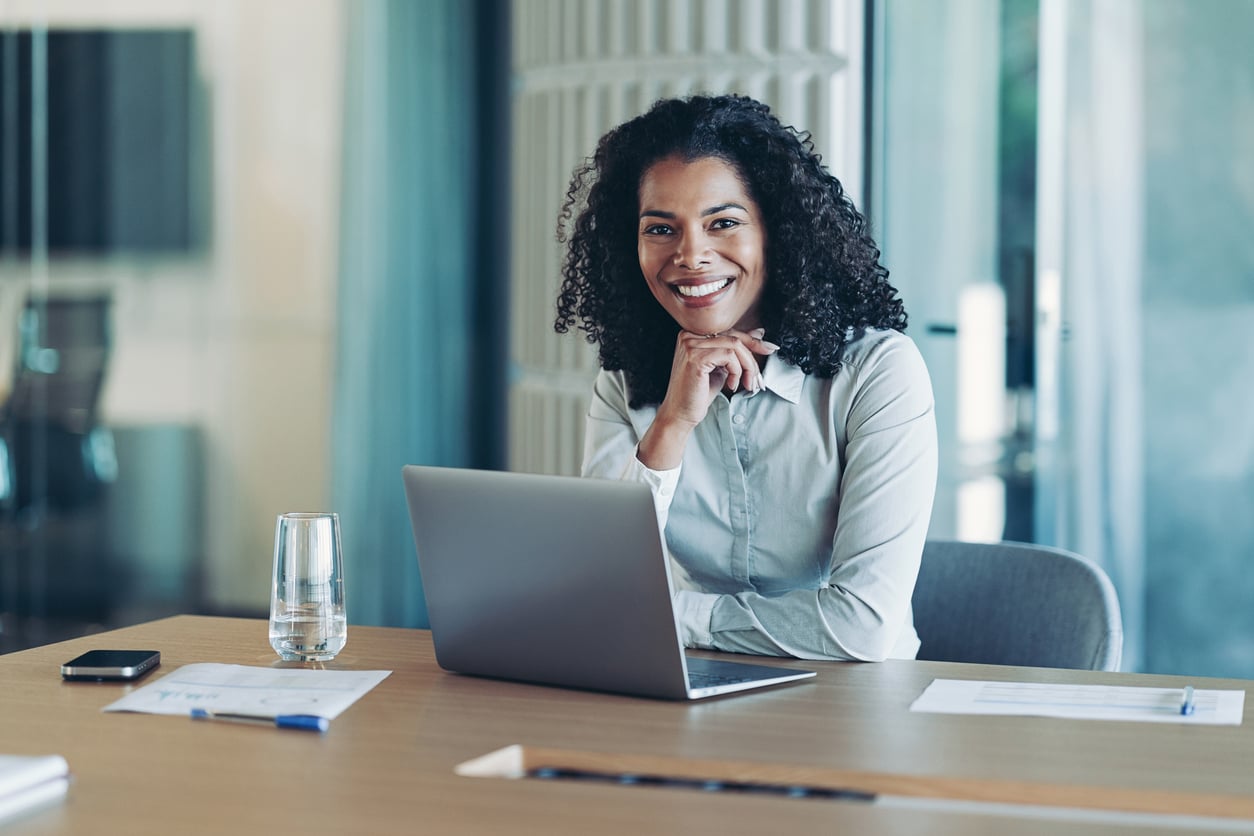 Smiling mediator sitting at laptop