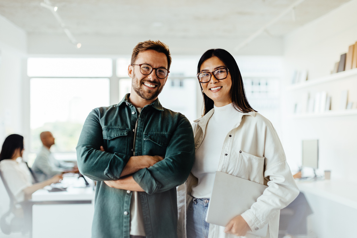 Two people standing in an office