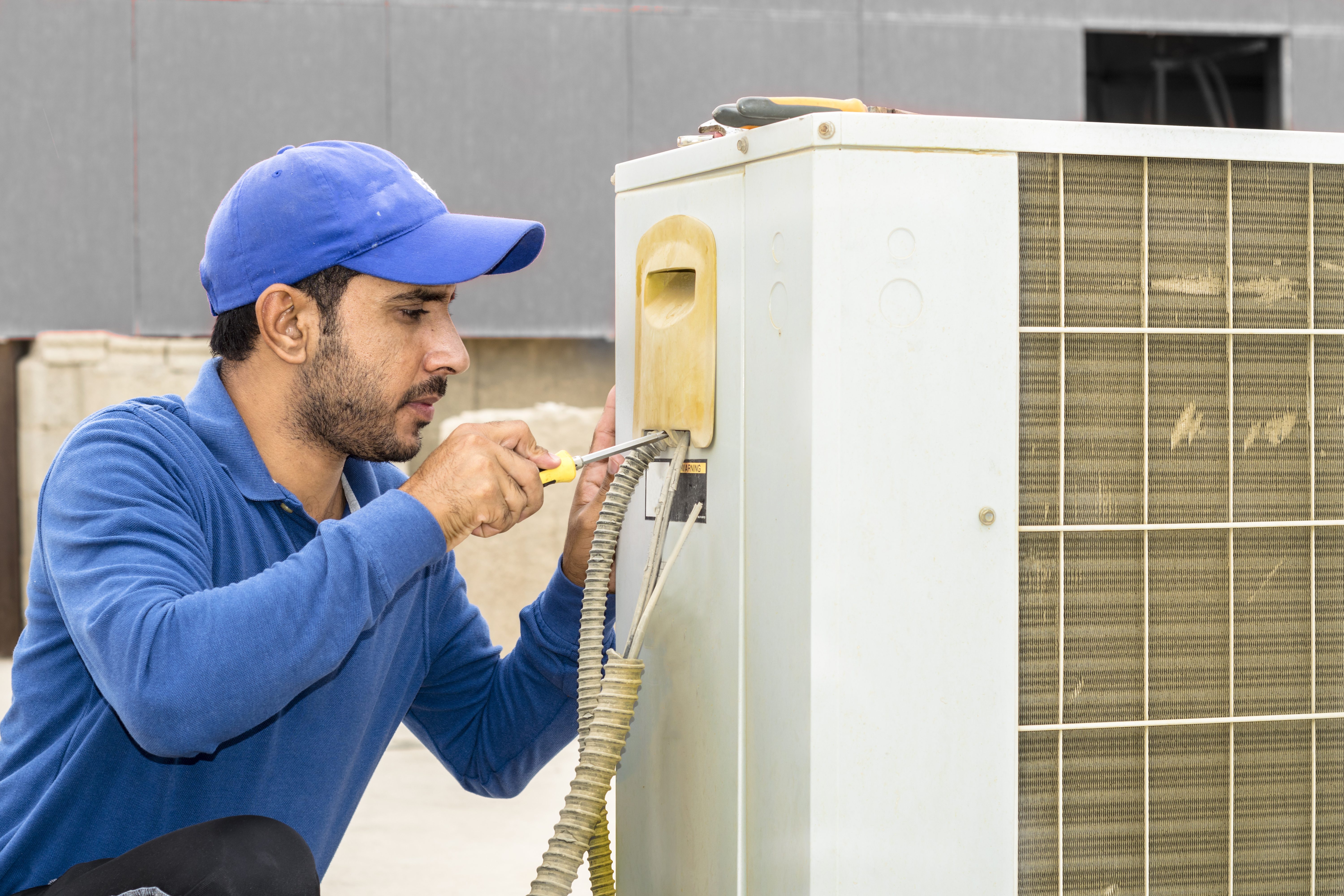 HVAC technician working on an air conditioning unit