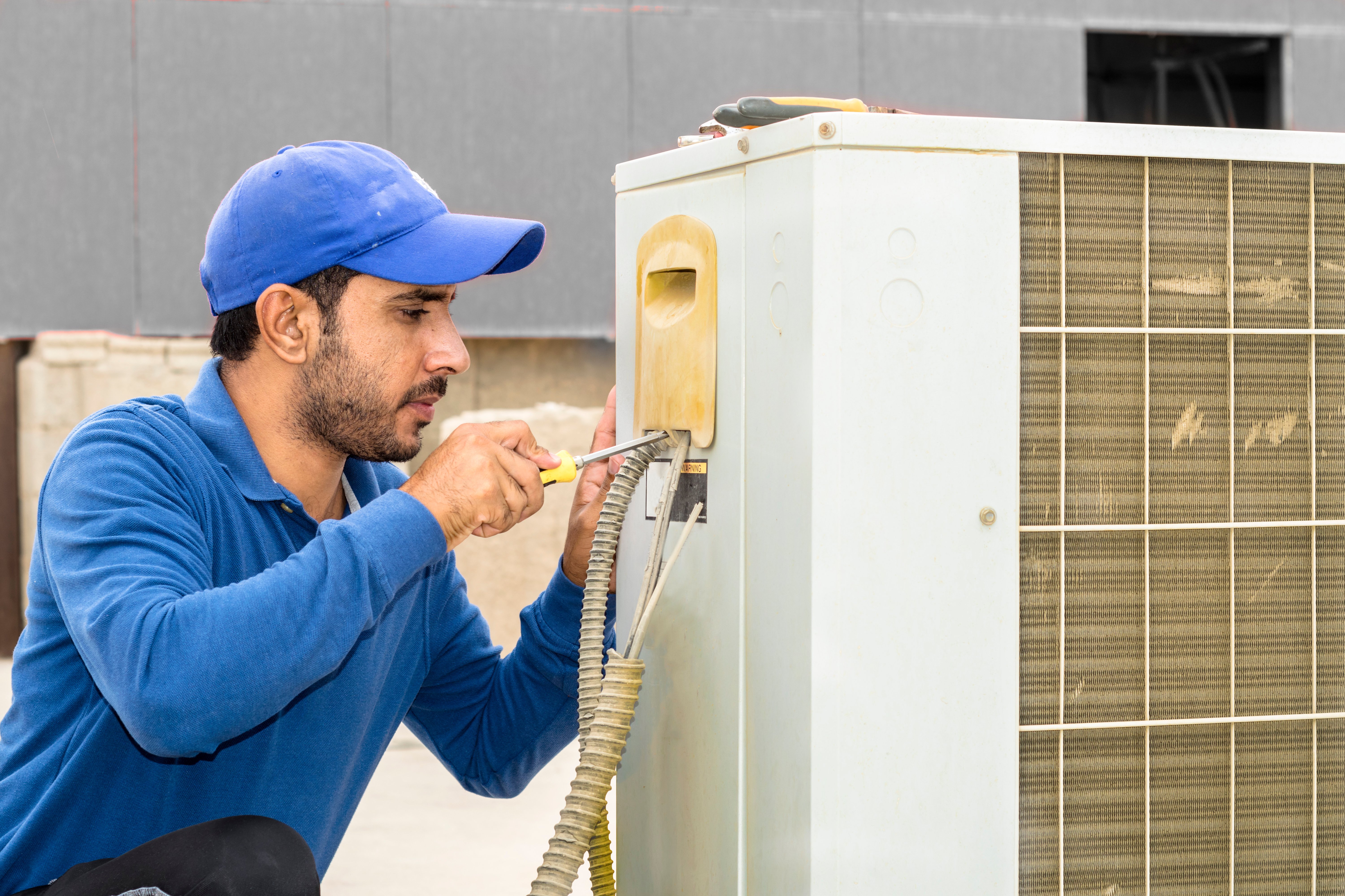 HVAC technician working on an air conditioning unit